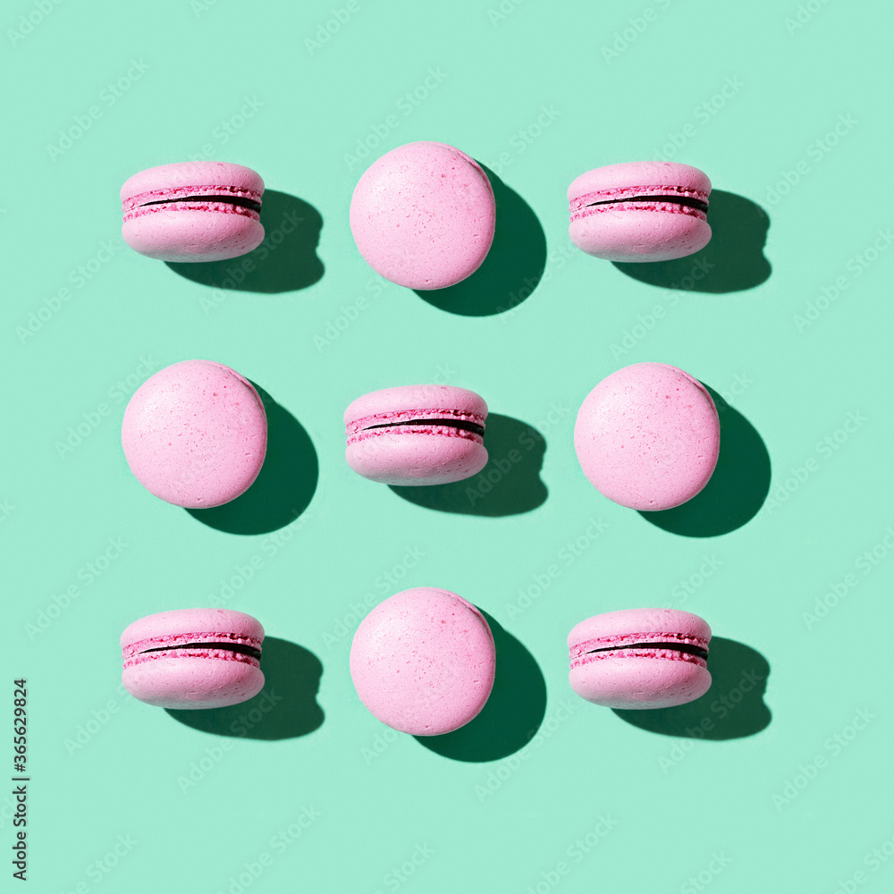 Fototapeta premium Regular creative pattern of colorful french cookies macarons.