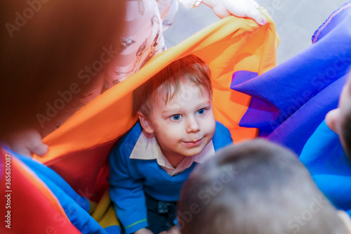 little boy playing in a tent