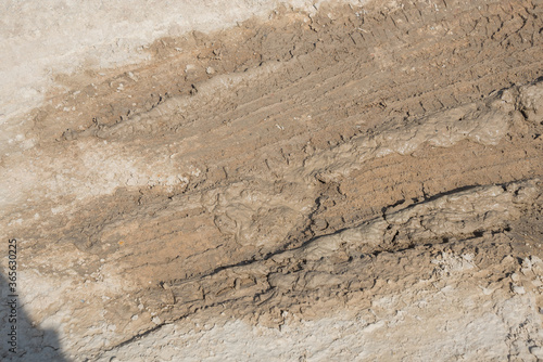 Wheel track on road muddy. Mud texture background.