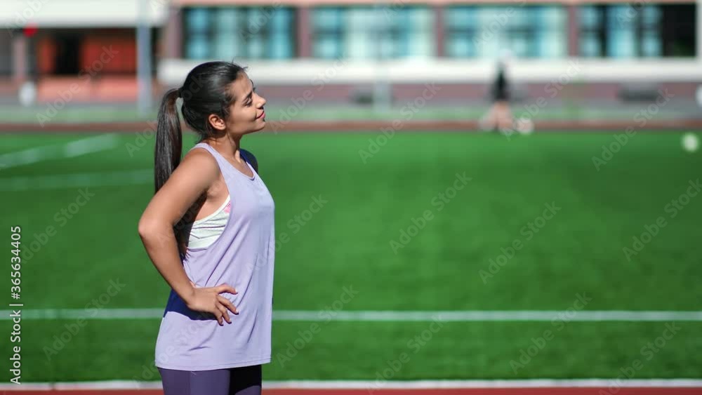 Smiling woman in sportswear training outdoor at football field. Shot on RED Raven 4k Cinema Camera Smiling woman in sportswear training outdoor at football field. Shot on RED Raven 4k Cinema Camera