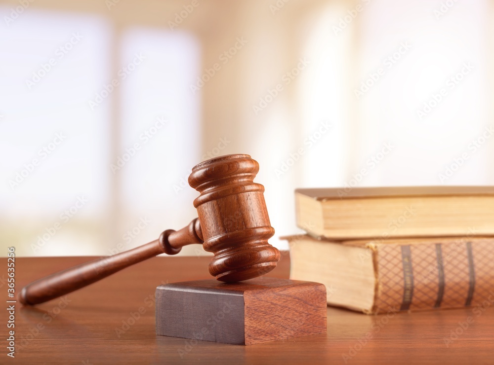 Wooden judge hammer with books on desk Wooden judge hammer with books on desk