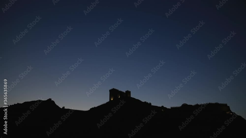 Ancient Genoese fortress in Sudak town. Panorama view after sunset. Crimea. Ancient Genoese fortress in Sudak town. Panorama view after sunset. Crimea.