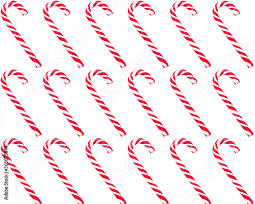 Christmas candy cane lied evenly in row on white background. Flat lay and top view. Traditional christmas candy.