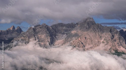 Unusual view of the Sesto Dolomites in Italy wrapped in clouds from top to bottom as seen from Carnic Peace Trail from Sillianer refuge to Obstansersee refuge on top of the Carnic Alps ridge  Austria.