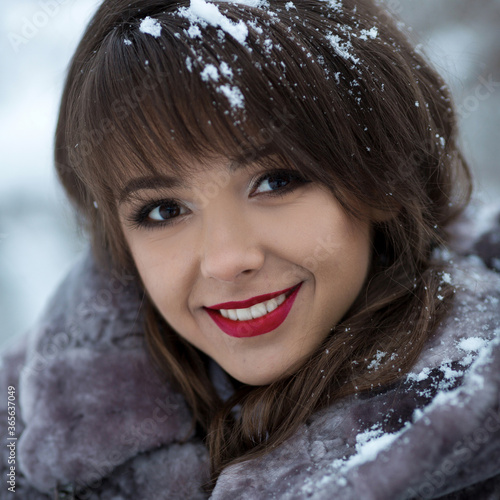 Beautiful portrait of cutel girl with  white healthy smile dentist, cosmetics, makeup, ice, snow, snowflakes in hair. photo