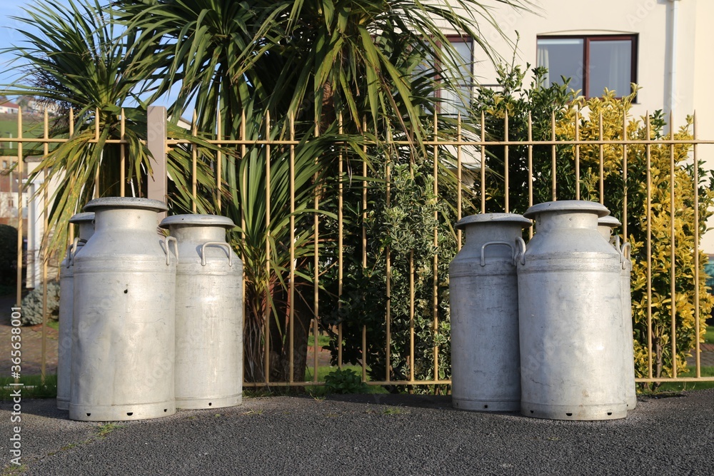 Milk cans on the platform of the old, railway station at Instow, Devon, England UK. Milk cans on the platform of the old, railway station at Instow, Devon, England UK.