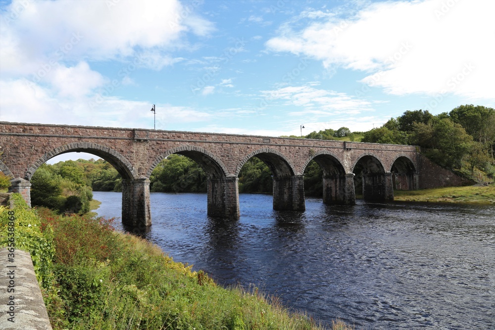 The historic seven arches bridge spanning the Newport River flowing through County Mayo, Ireland.