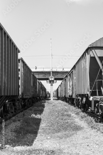 Black and white photo of railway carriages going into perspective