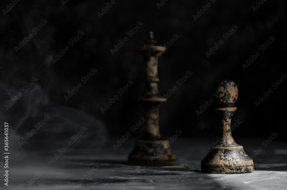 old wooden chess on black background in smoke