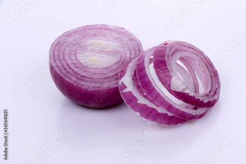 Red onion with cut in half isolated on dark background.
