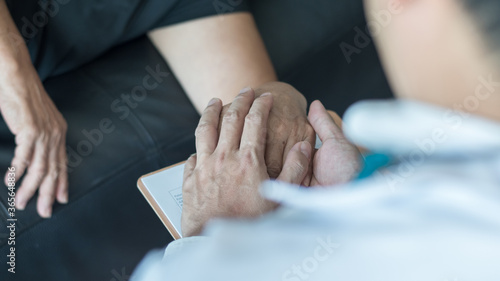 Parkinson disease patient  Alzheimer elderly senior  Arthritis person s hand in support of geriatric doctor or nursing caregiver  for disability awareness day  ageing society care service