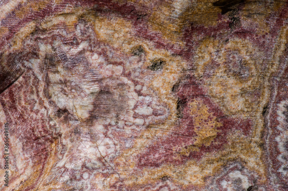 Unusual stone texture, with pink, yellow, brown lines. Abstract stone painting.