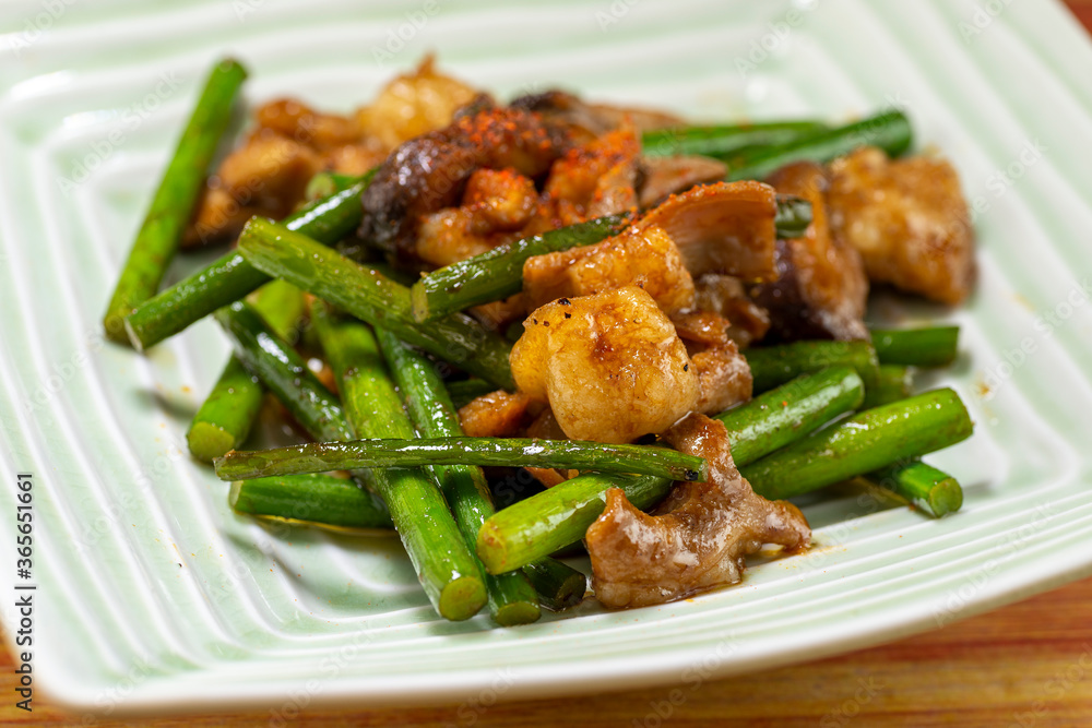 Grilled beef tripe with garlic stalk in a plate in Japan Grilled beef tripe with garlic stalk in a plate in Japan