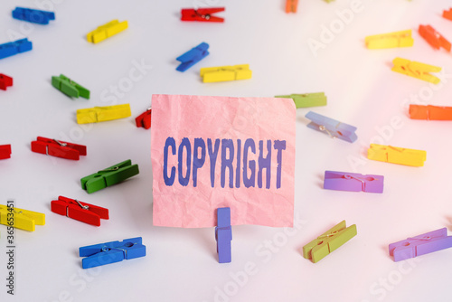 Conceptual hand writing showing Copyright. Concept meaning exclusive legal right to print write perform film record literary Colored clothespin papers empty reminder white floor office