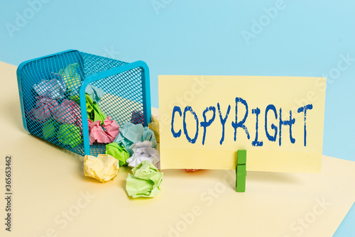 Handwriting text writing Copyright. Conceptual photo exclusive legal right to print write perform film record literary Trash bin crumpled paper clothespin empty reminder office supplies tipped