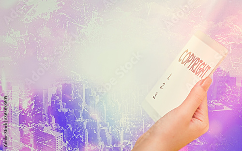 Conceptual hand writing showing Copyright. Concept meaning exclusive legal right to print write perform film record literary Modern gadgets white screen under colorful bokeh background