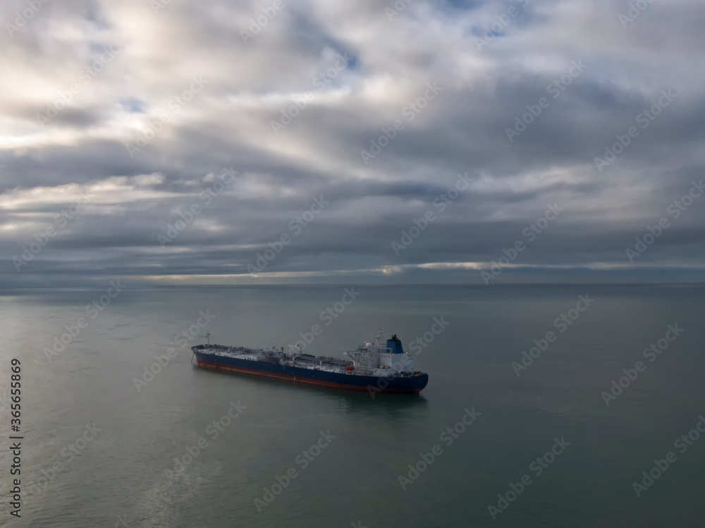 drone photo of a suezmax tanker at anchor in cloudy weather