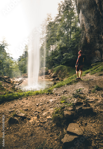 Man standing near big Waterfall in Austria in Summer photo