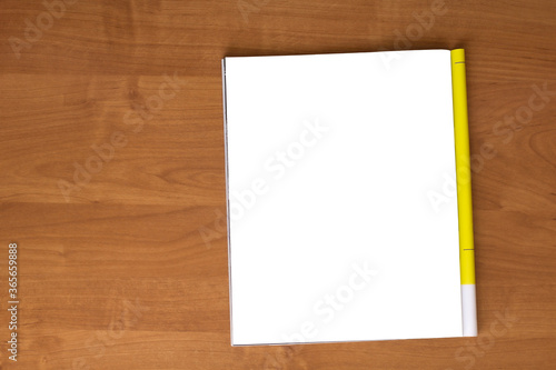 Mockup of magazine on wooden table. Blank isolated page. Top view