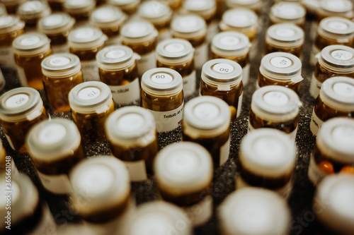 pharmaceuticals in numbered glasses, ampoules with numbers on it filled with pills, capsules, numbers in close up, symbol of pharmacy and healthcare