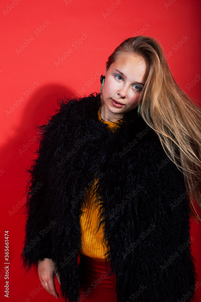 young pretty fashion teenage girl on bright red background posing emotional, happy smiling lifestyle people concept young pretty fashion teenage girl on bright red background posing emotional, happy smiling lifestyle people concept