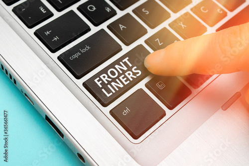 Word writing text Frontliners. Business photo showcasing most important or influential position in a debate or movement. Pc keyboard key with pointing finger above background copy space photo