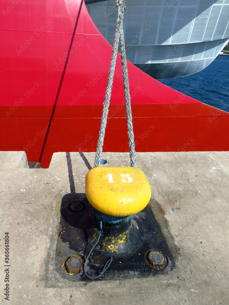 Modern red and gray ship bow. Mooring bollard with heavy duty mooring