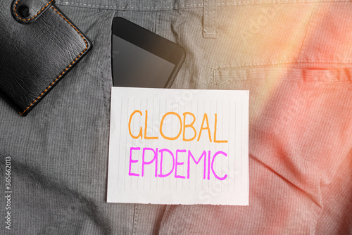 Conceptual hand writing showing Global Epidemic. Concept meaning a rapid spread of a communicable disease over a wide geographic area Smartphone device inside trousers front pocket with wallet photo