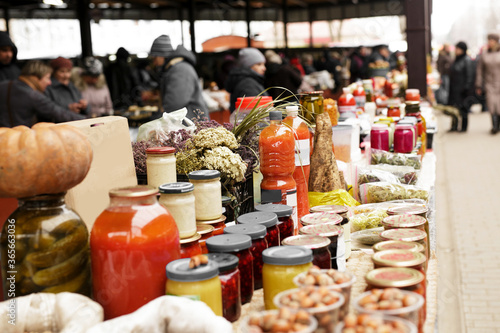 Food market stall with big choice of products, drinks, conservation, spices, sauces, honey