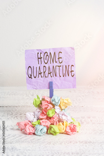 Writing note showing Home Quarantine. Business concept for Encountered a possible exposure from the public for observation Reminder pile colored crumpled paper clothespin wooden space photo