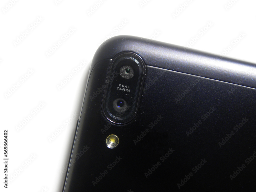 Dual camera and flash on back of black color smartphone on white background