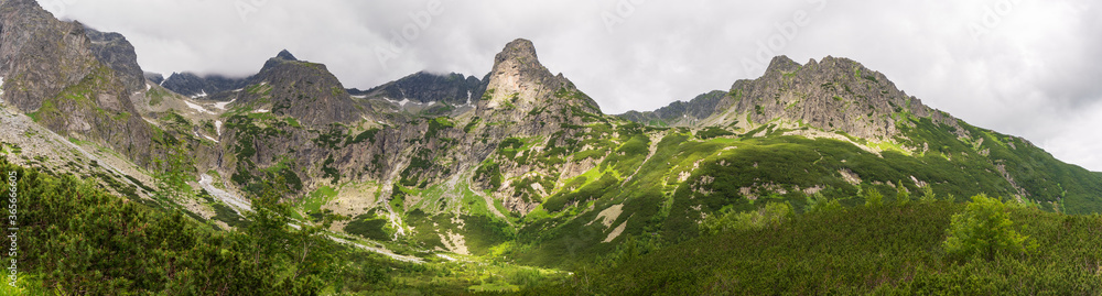 Mountain landscape with rocks and creeping fog. High peaks in the clouds, cold weather. Tourism in the mountains, tatry slovakia jahnaci stit