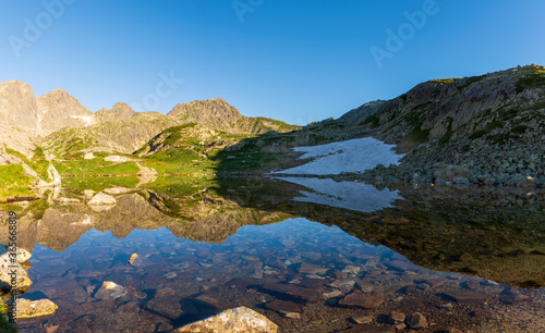 Wonderful spring sunrise of sesterske pleso . Amazing morning view of Tatras mountains. Slovakia, Europe. Beauty of nature concept background.