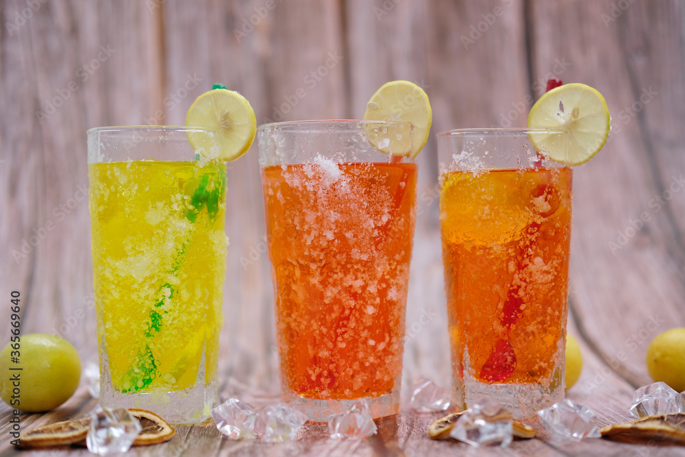 Refreshing summer drinks with alcohol on wood table and cool drinks with lemonade Refreshing summer drinks with alcohol on wood table and cool drinks with lemonade