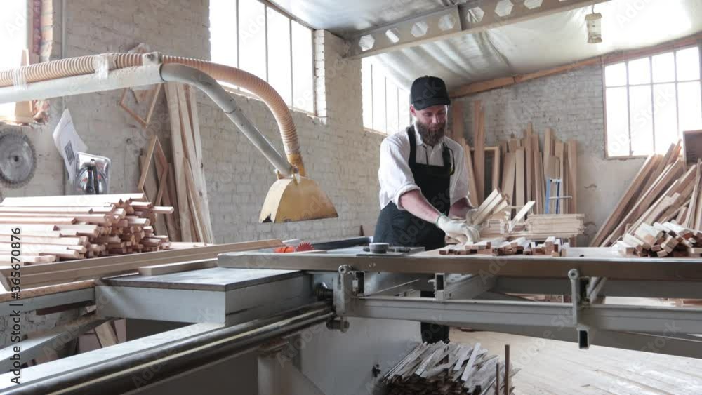 Carpenter working in his own woodshop with timber Carpenter working in his own woodshop with timber