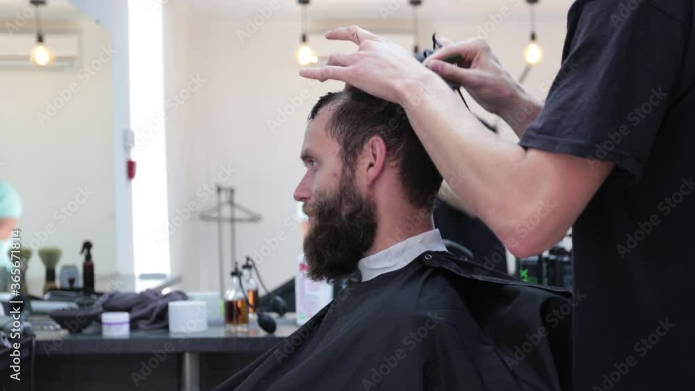 Man getting his haircut done at the local barbershop Man getting his haircut done at the local barbershop