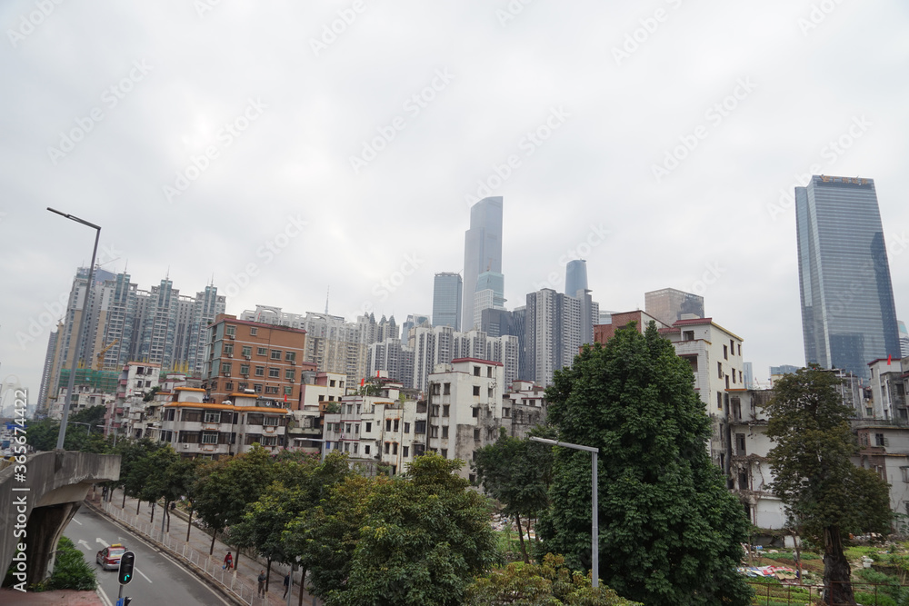 City skyline with an interesting cloudy sky behind. Panorama of full skyline with all the towers and buildings.