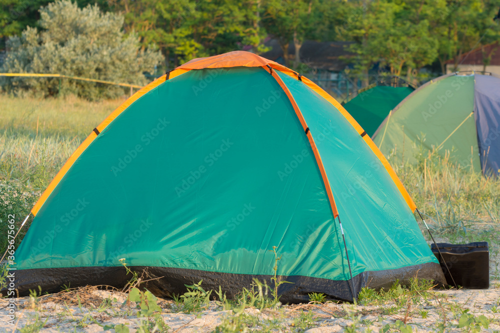 Green camping tent and camp by the sea.