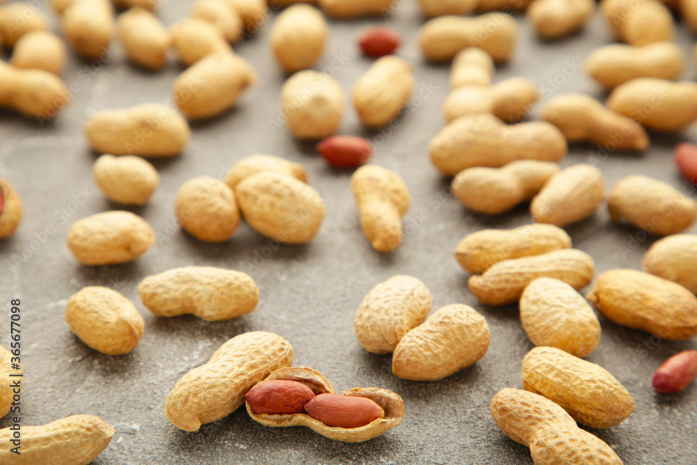 Many peanuts in shells on grey background. Food texture Many peanuts in shells on grey background. Food texture