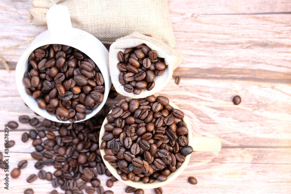Fototapeta premium coffee beans on old wood table background, space for text