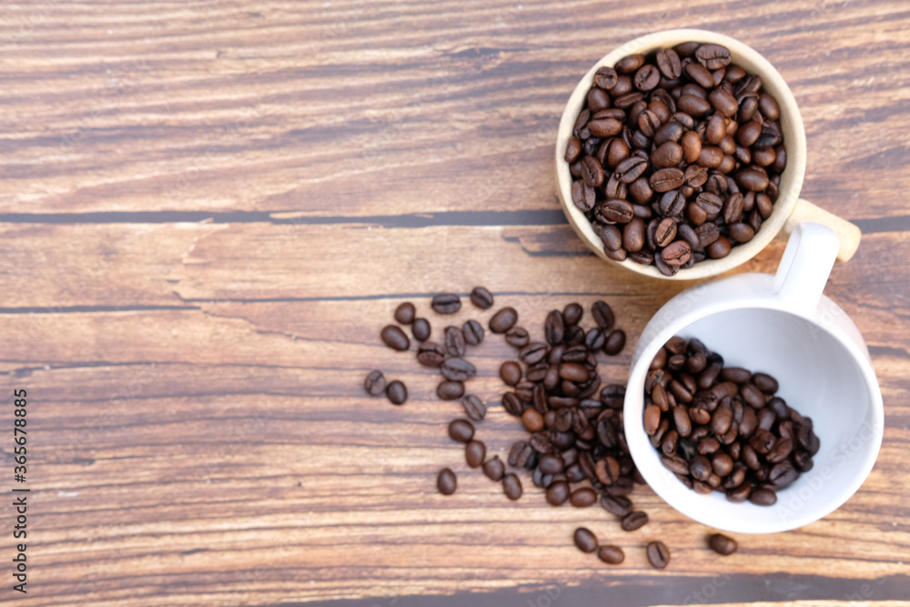 coffee beans on old wood table background, space for text coffee beans on old wood table background, space for text