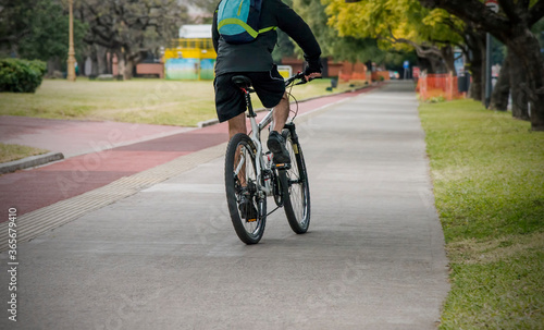 Man riding a bicycle exercising in a city parke outdoors