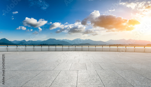 Empty square floor and mountain landscape in hangzhou at sunset.