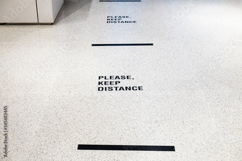 Please keep distance  sign on the floor inside department store for people to wait in line. New normal for prevent and stay safe from Corona virus or Covid-19.
