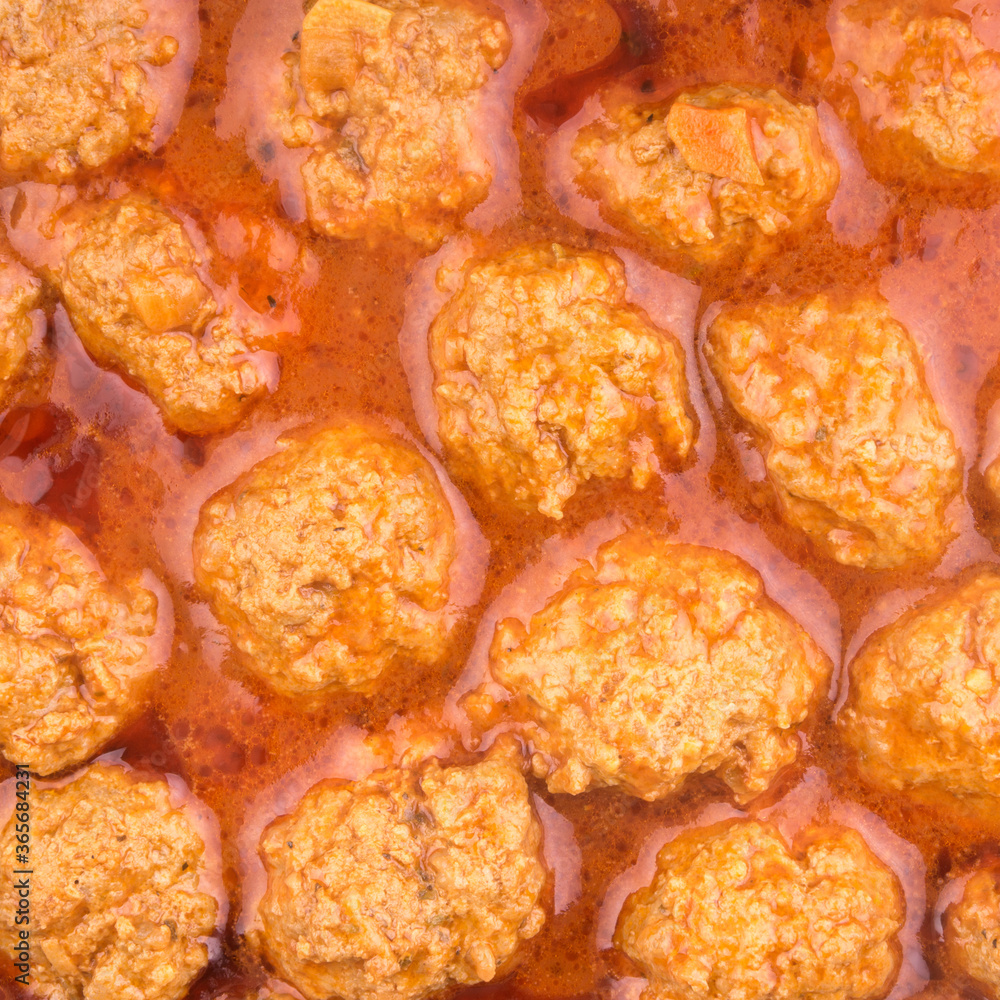 Culinary background - meatballs in red tomato sauce, top view, close-up Culinary background - meatballs in red tomato sauce, top view, close-up