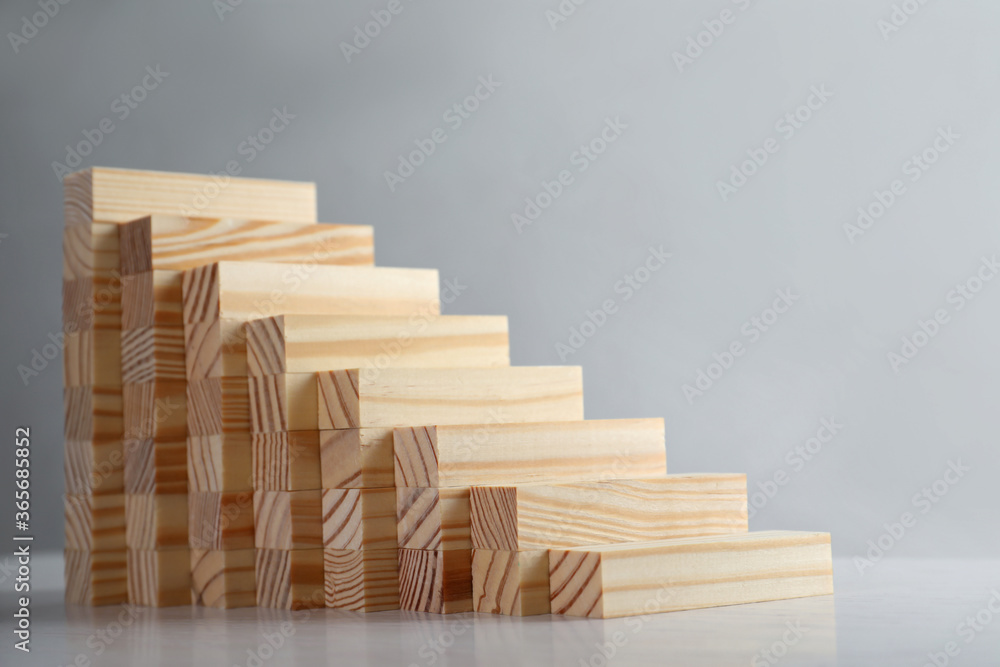 Steps made with wooden blocks on light background, space for text. Career ladder Steps made with wooden blocks on light background, space for text. Career ladder