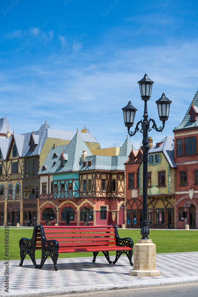Fototapeta premium Street lamppost against the blue sky background of decorative old buildings on the island of Phu Quoc, Vietnam