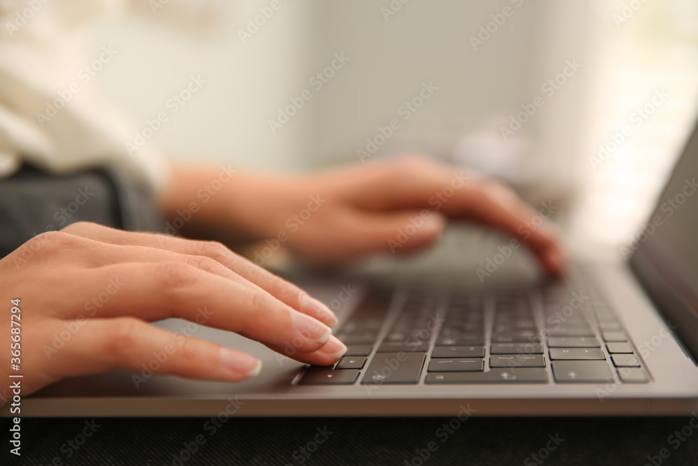 Woman working with modern laptop indoors, closeup Woman working with modern laptop indoors, closeup