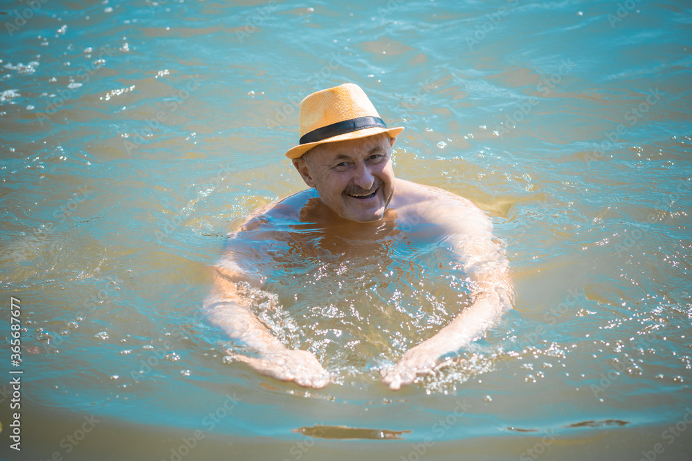 Happy senior man swiming at water, at nature and rest, lifestyle of people on retired