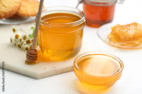 Tasty fresh honey on white table, closeup